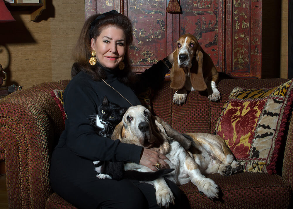 Carol Byers is seen in the photo with her rescued Basset Hounds Humphrey, Emily and Katie Cat. Photo by Shlomit Schatzmayr